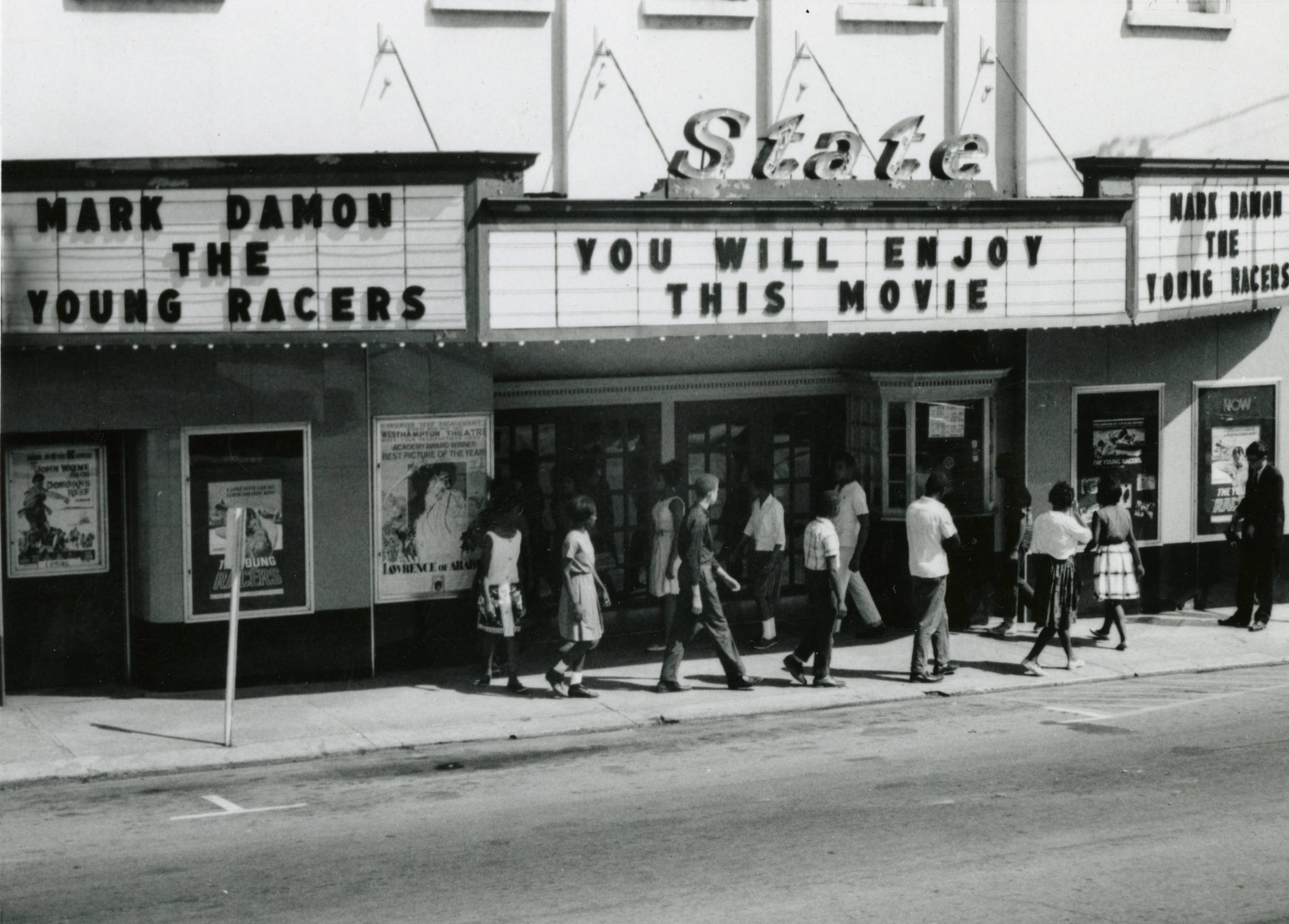 An image of the state theater with a group of picketers in front of the entrance